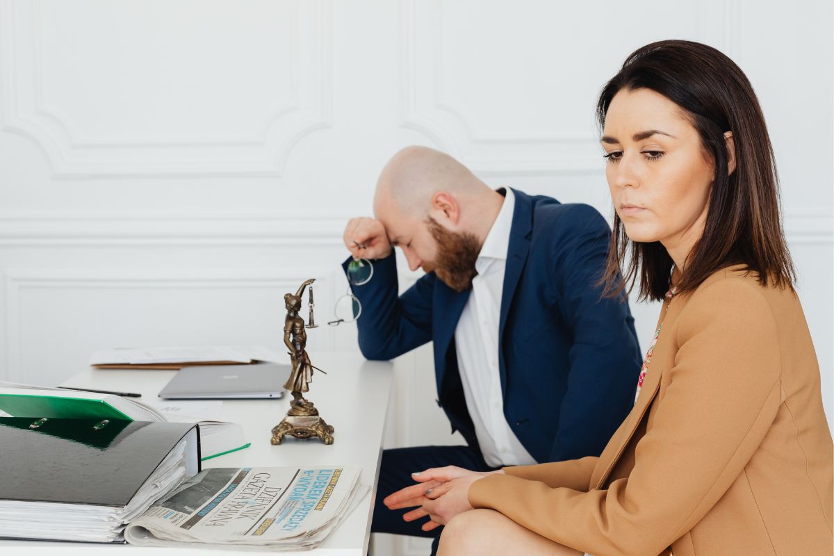 Couple meeting with a lawyer about a legal issue. Couple meeting with a lawyer about a legal issue.