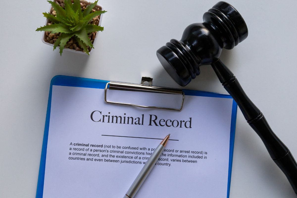 Criminal record document with a gavel and pen. Criminal record document with a gavel and pen.