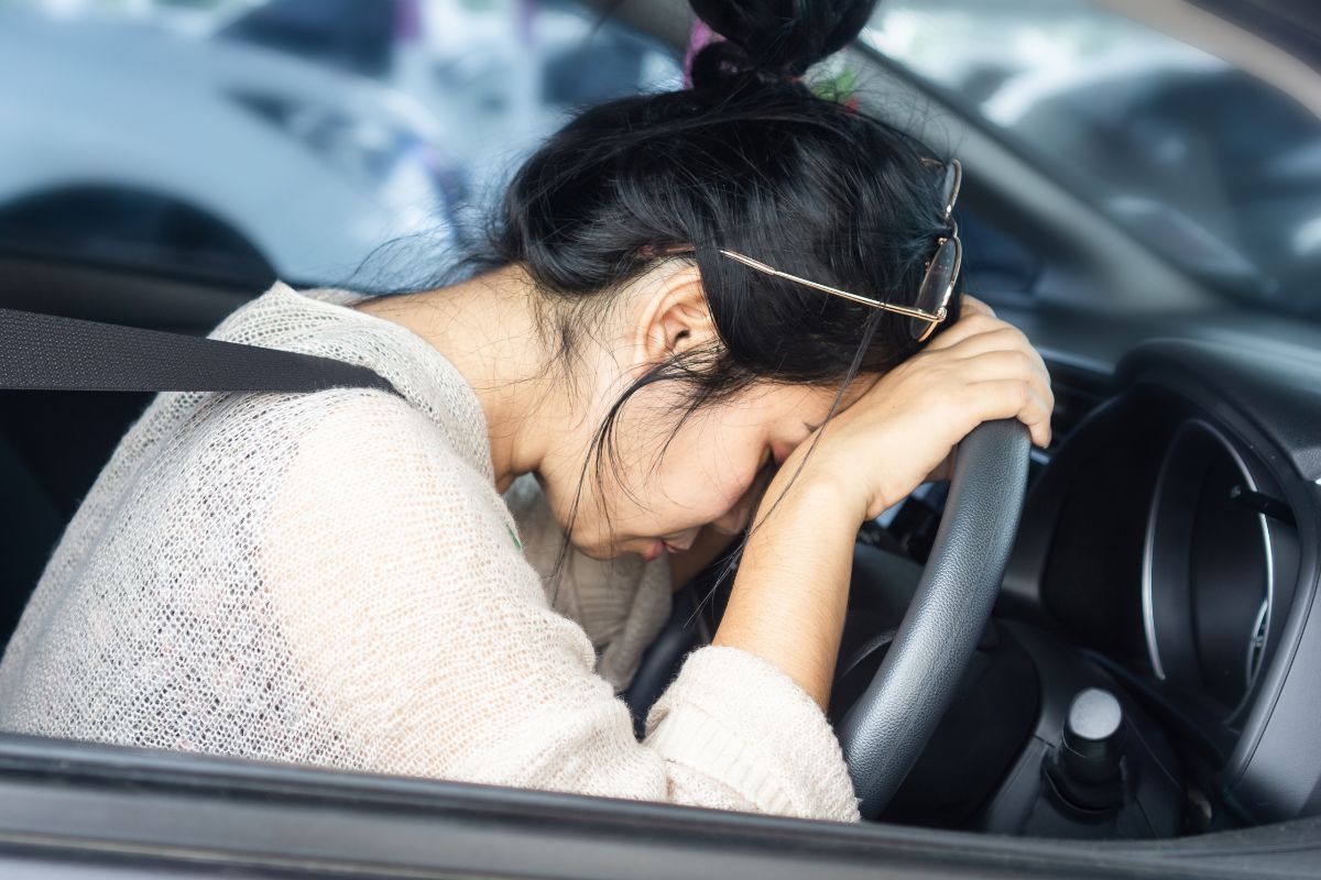 Distressed woman leaning on her steering wheel. Distressed woman leaning on her steering wheel.