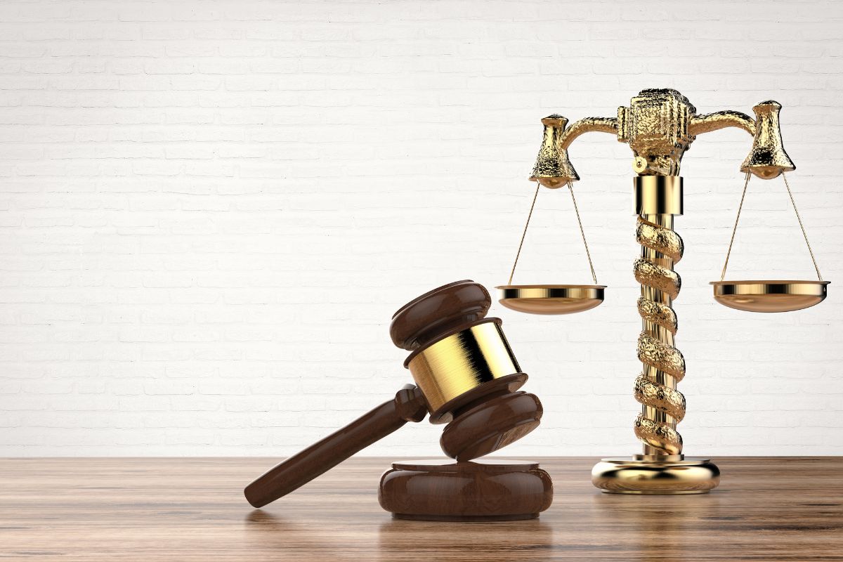 Gavel and scales of justice on a desk. Gavel and scales of justice on a desk.