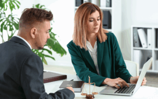 Lawyer and client meeting in an office to discuss legal consultation costs.