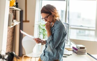 A woman is reading documents.