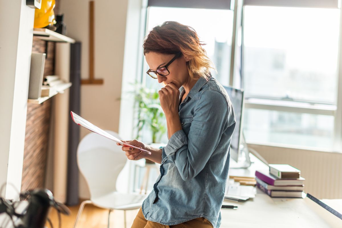 A woman is reading documents.