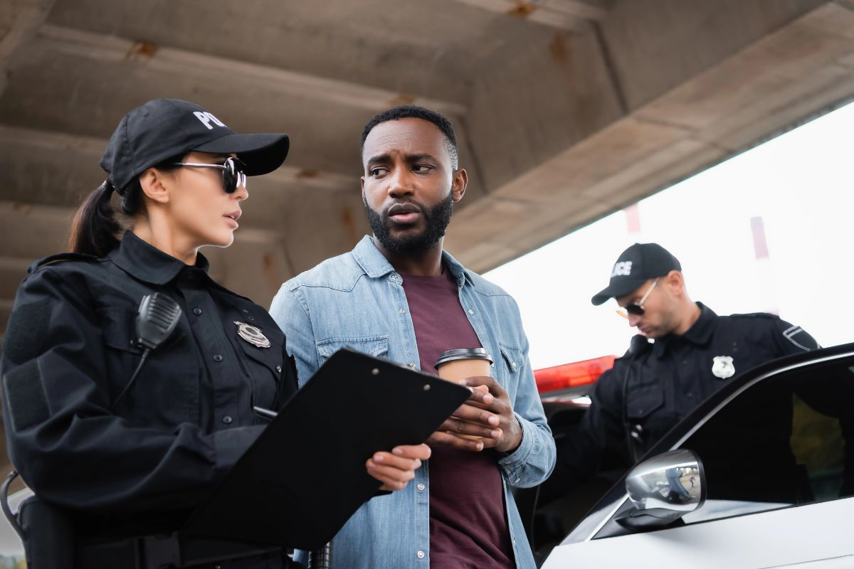 A man is being interviewed by a police officer.