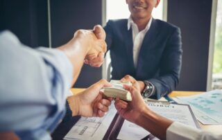 A client handing payment to a lawyer.