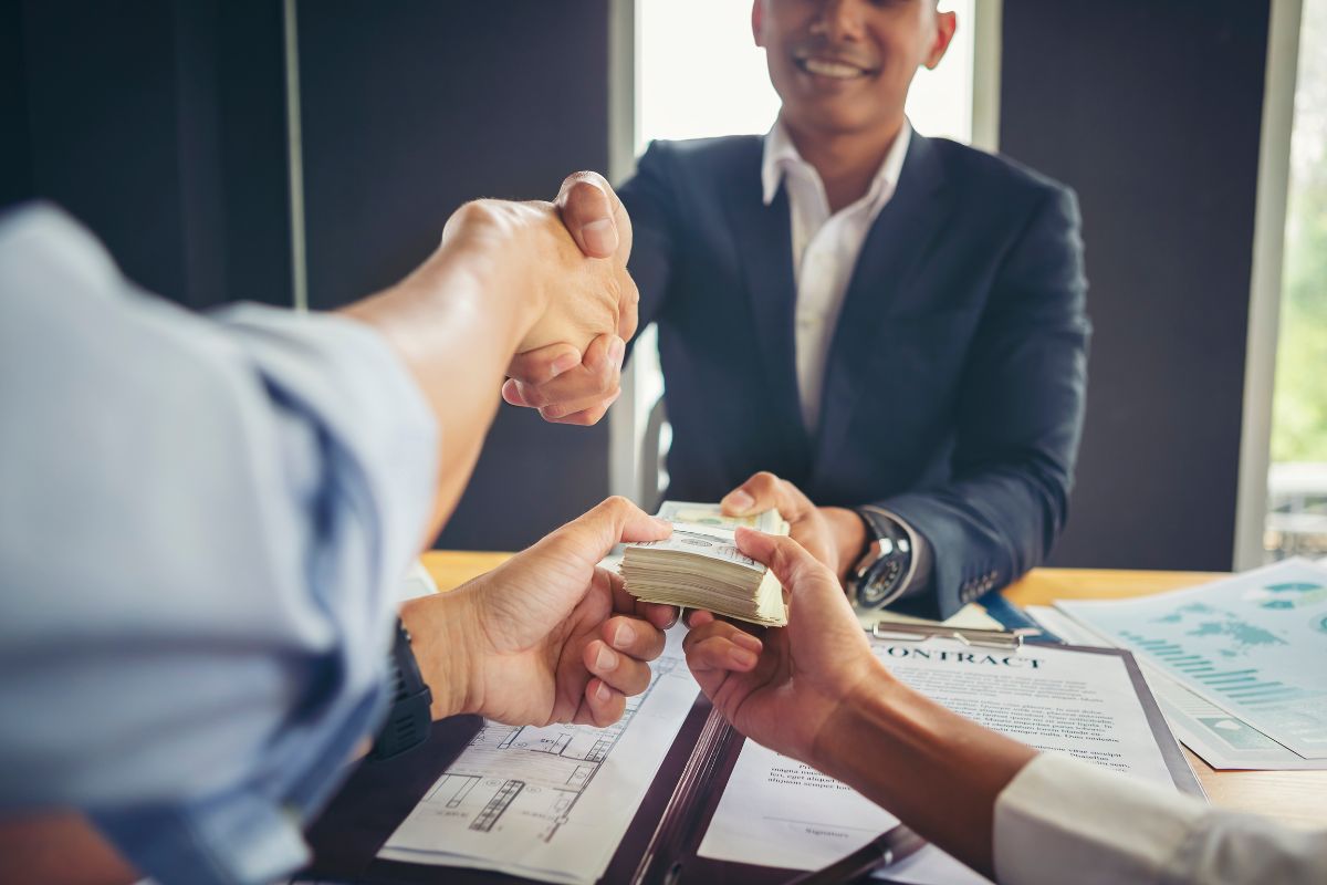 A client handing payment to a lawyer.