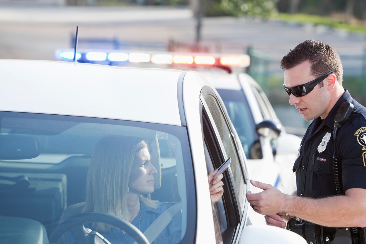 Police officer speaking to a woman.