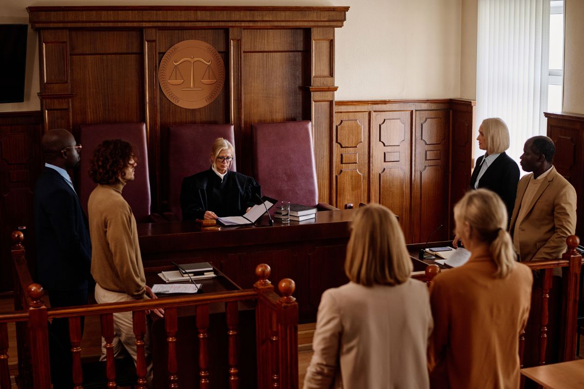 Group of people wearing professional attire in a courtroom.