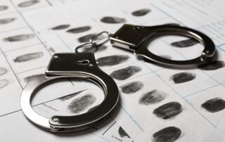 Handcuffs placed on a fingerprint record sheet.