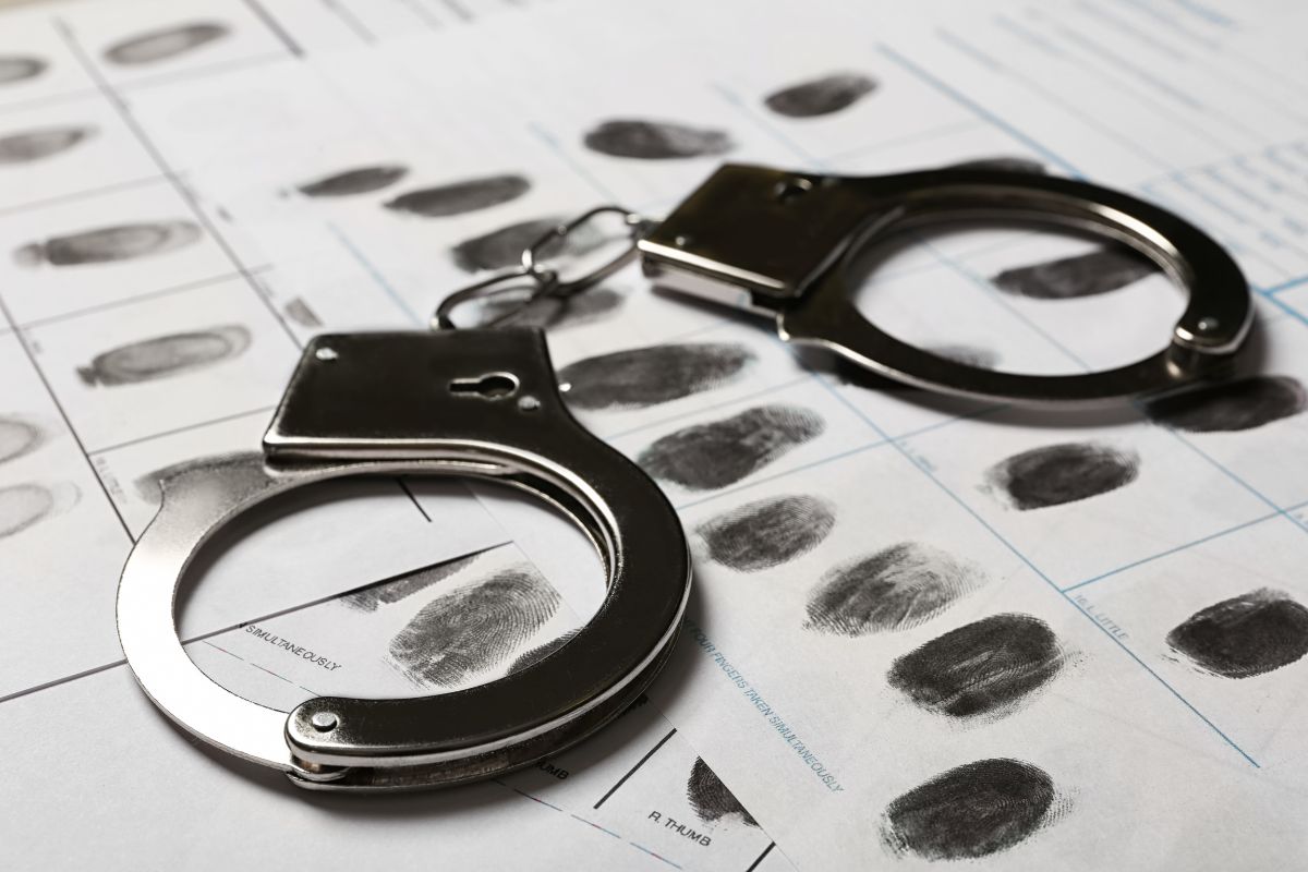 Handcuffs placed on a fingerprint record sheet.