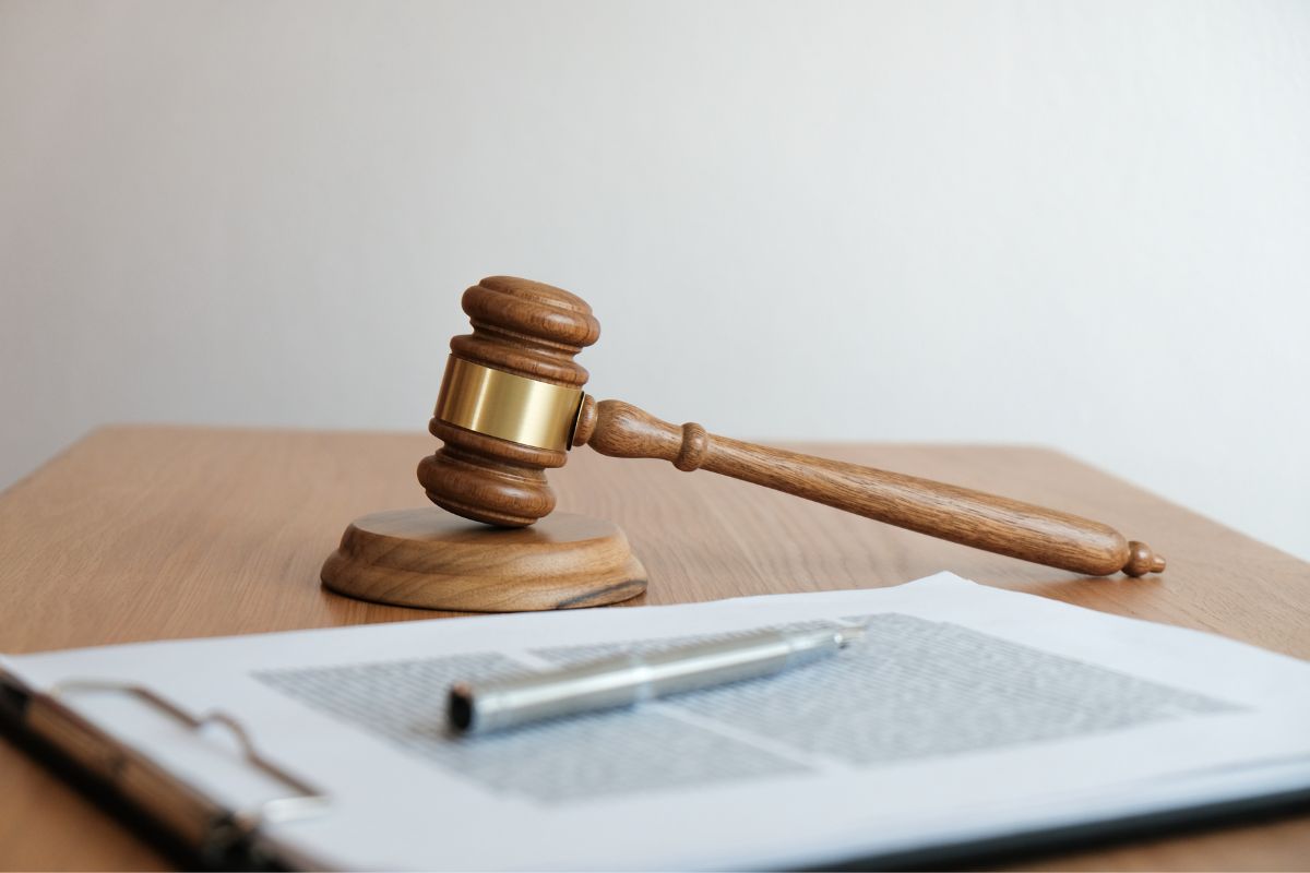 Judge's gavel beside legal document.