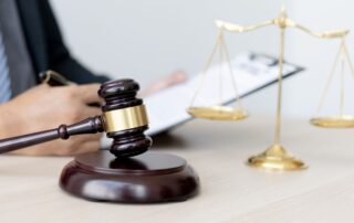 Judge’s gavel and scales of justice on desk.