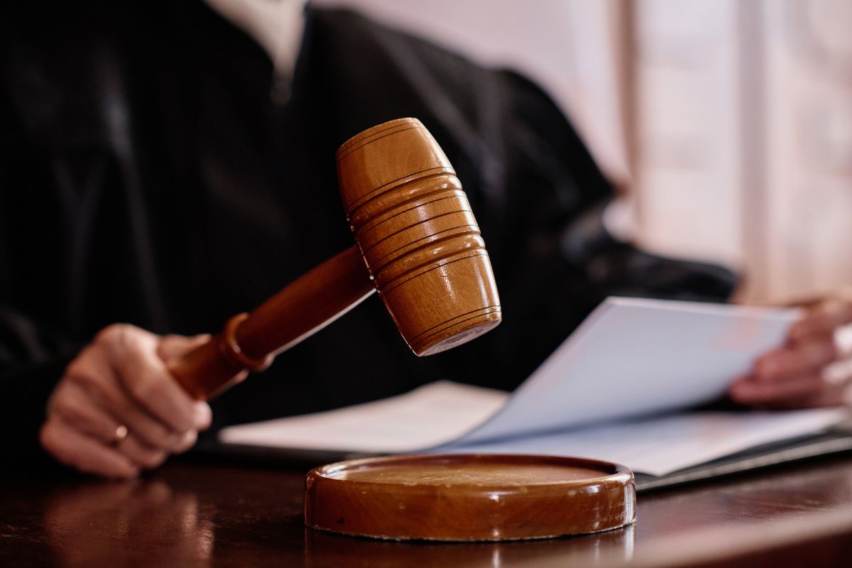 Judge holding a gavel in court.