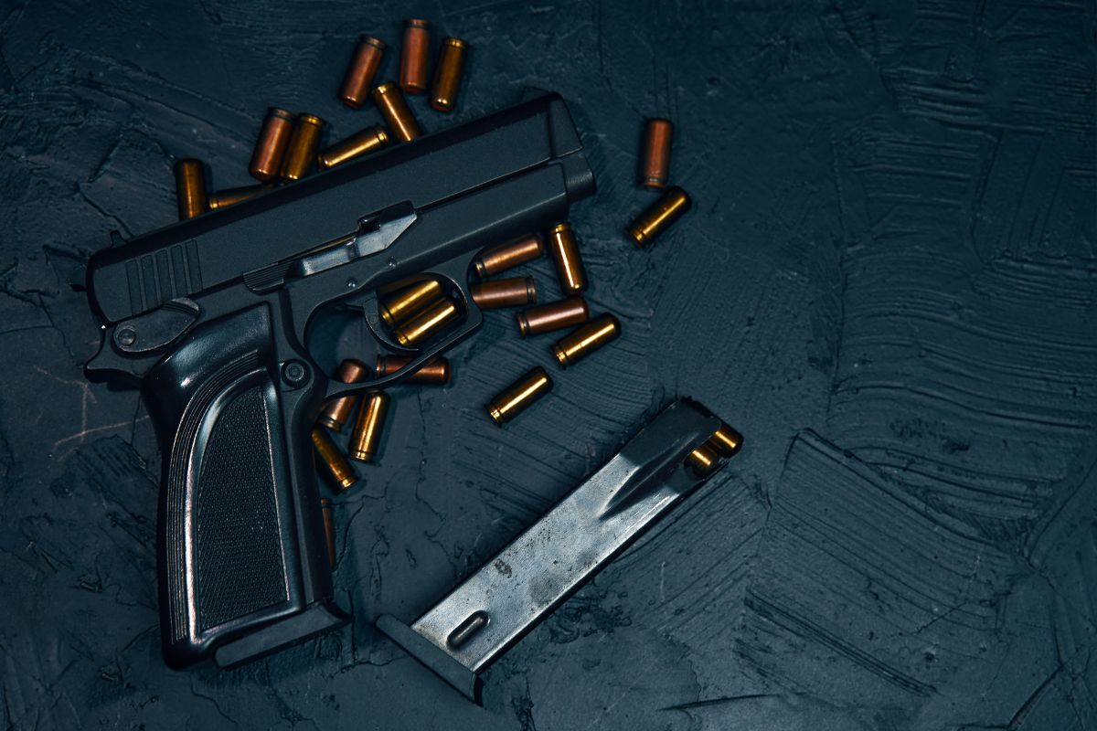 Handgun with loose bullets.