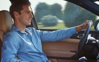 A man is driving a car confidently.