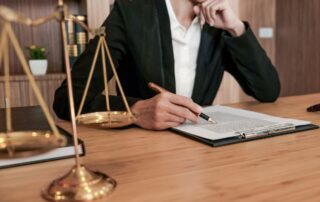 Lawyer reviewing legal documents at a desk.