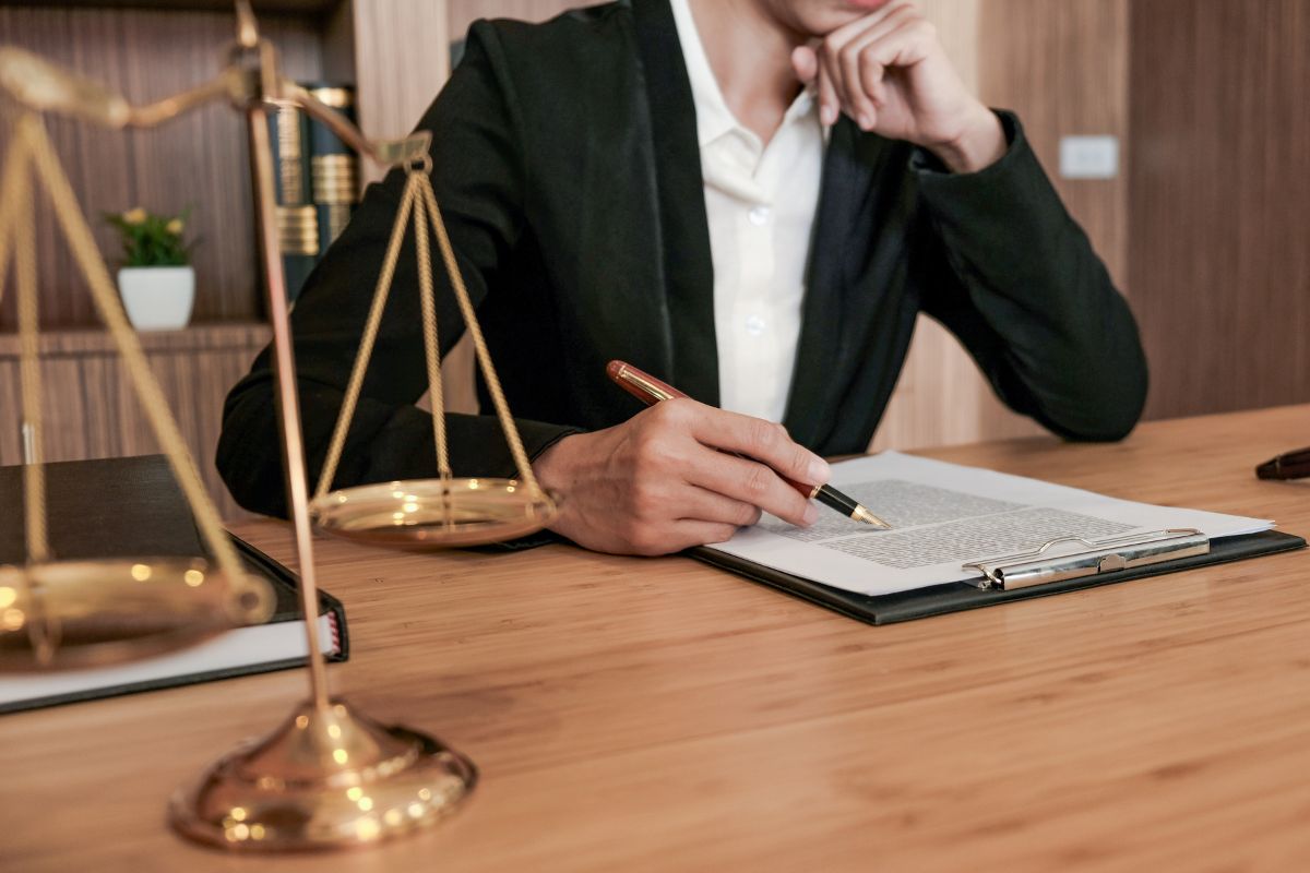 Lawyer reviewing legal documents at a desk.