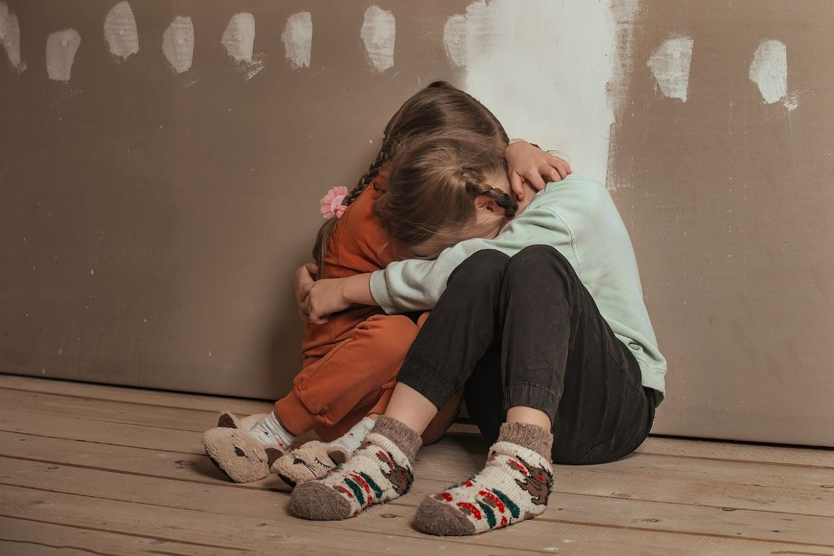 Two children hugging on the floor. Two children hugging on the floor.