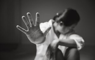 A woman raises her hand to stop.