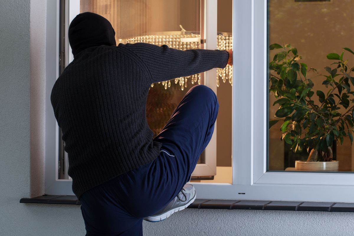 A burglar is getting into the house.