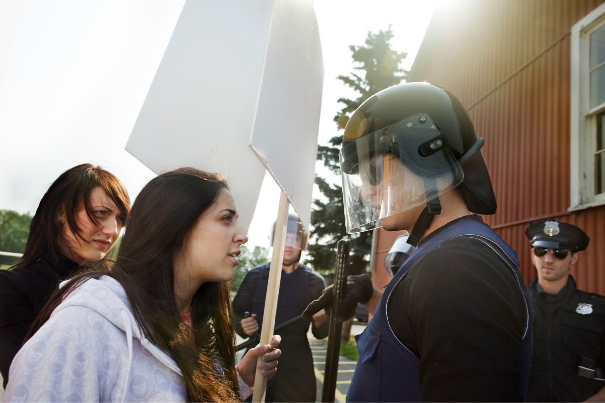 Protesters tries to work something out with the police officer.