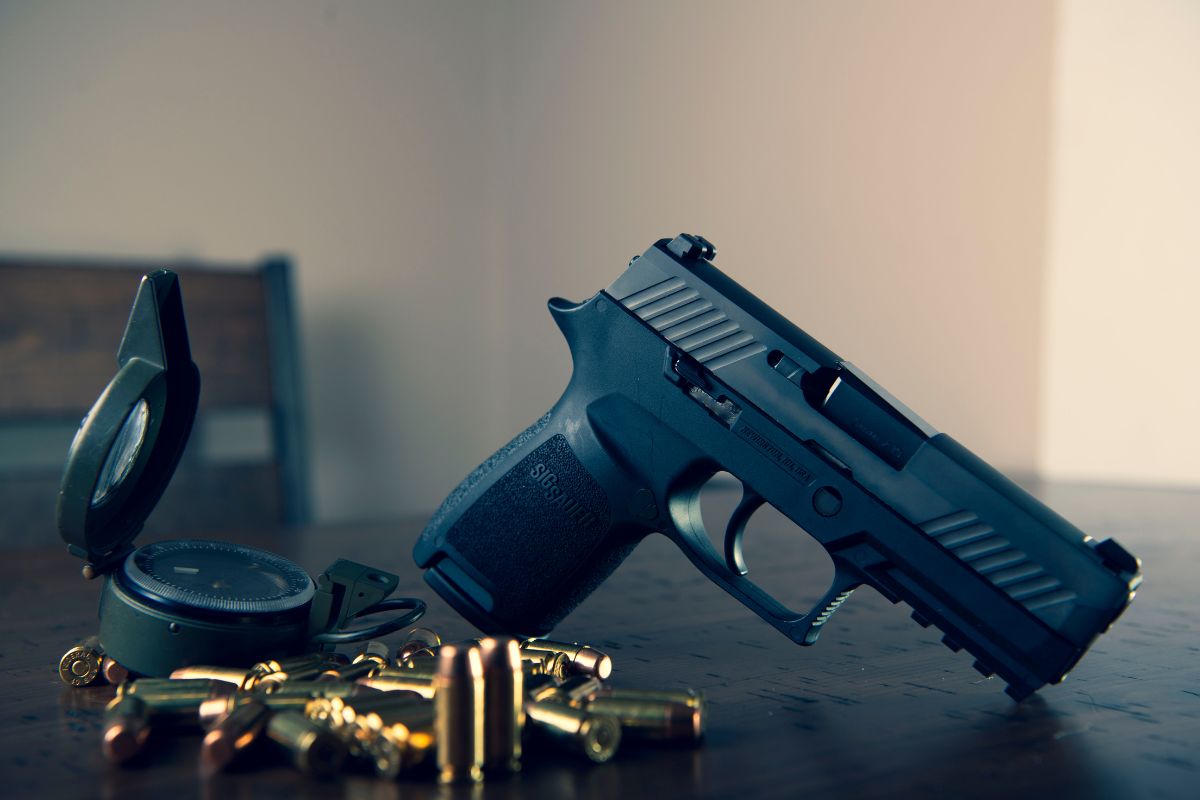Handgun with bullets on a table.