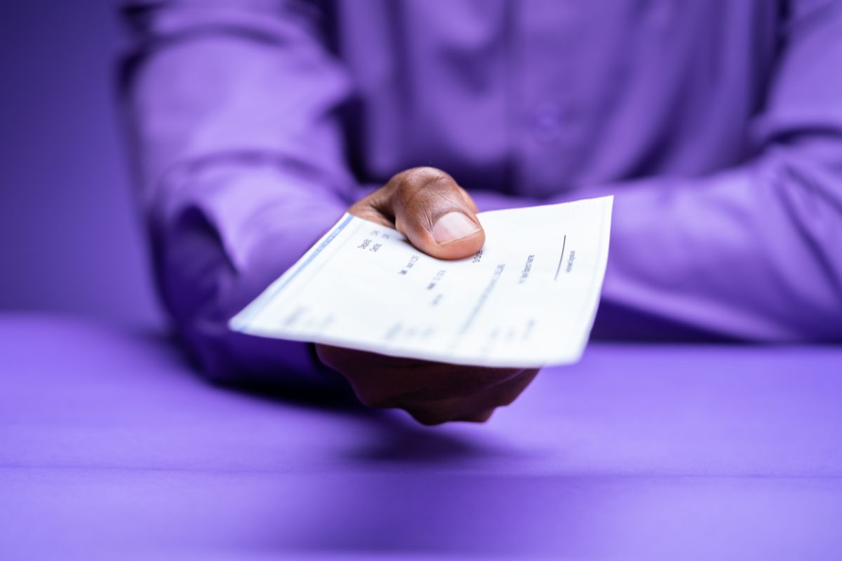 A person handing over a worthless cheque as payment.
