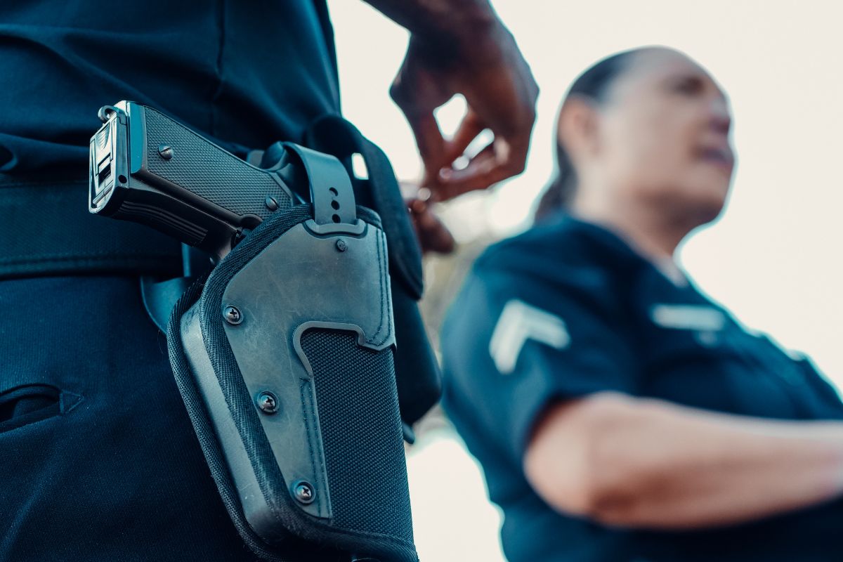 Close-up of a police officer’s holstered firearm.
