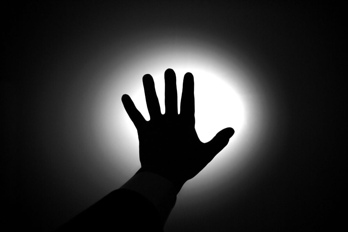 Silhouette of a hand against light.