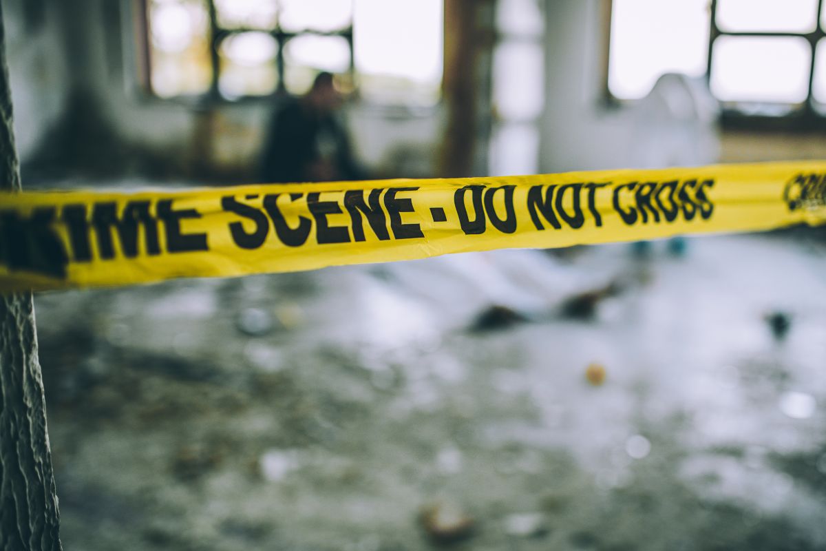 Detectives and forensics at a murder crime scene.