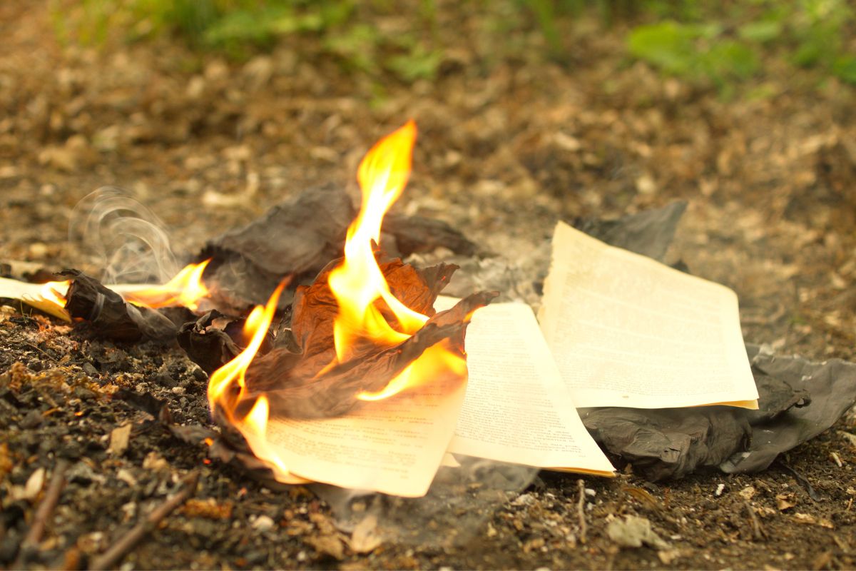 Burning papers and documents on the ground.
