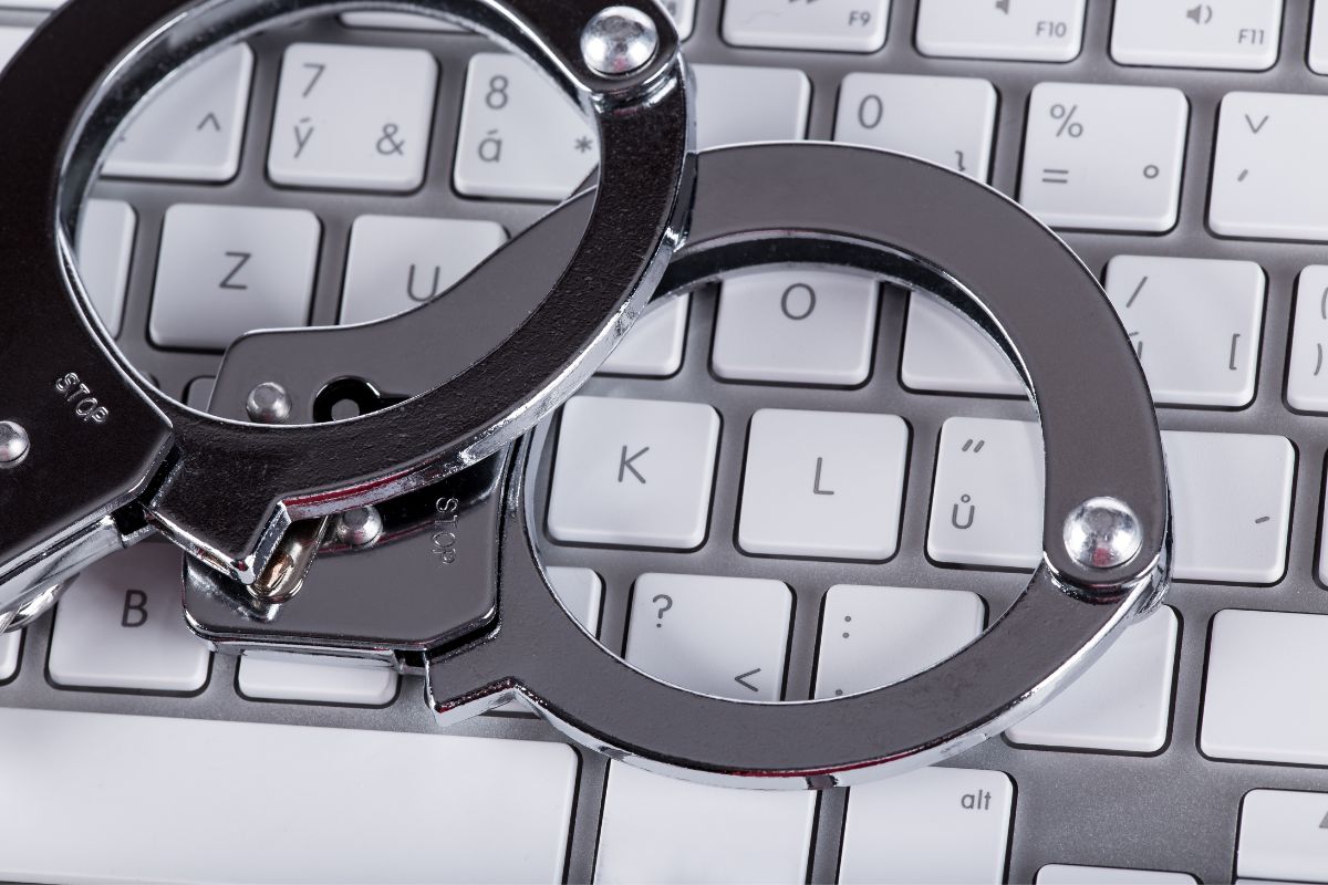Handcuffs placed on a computer keyboard.