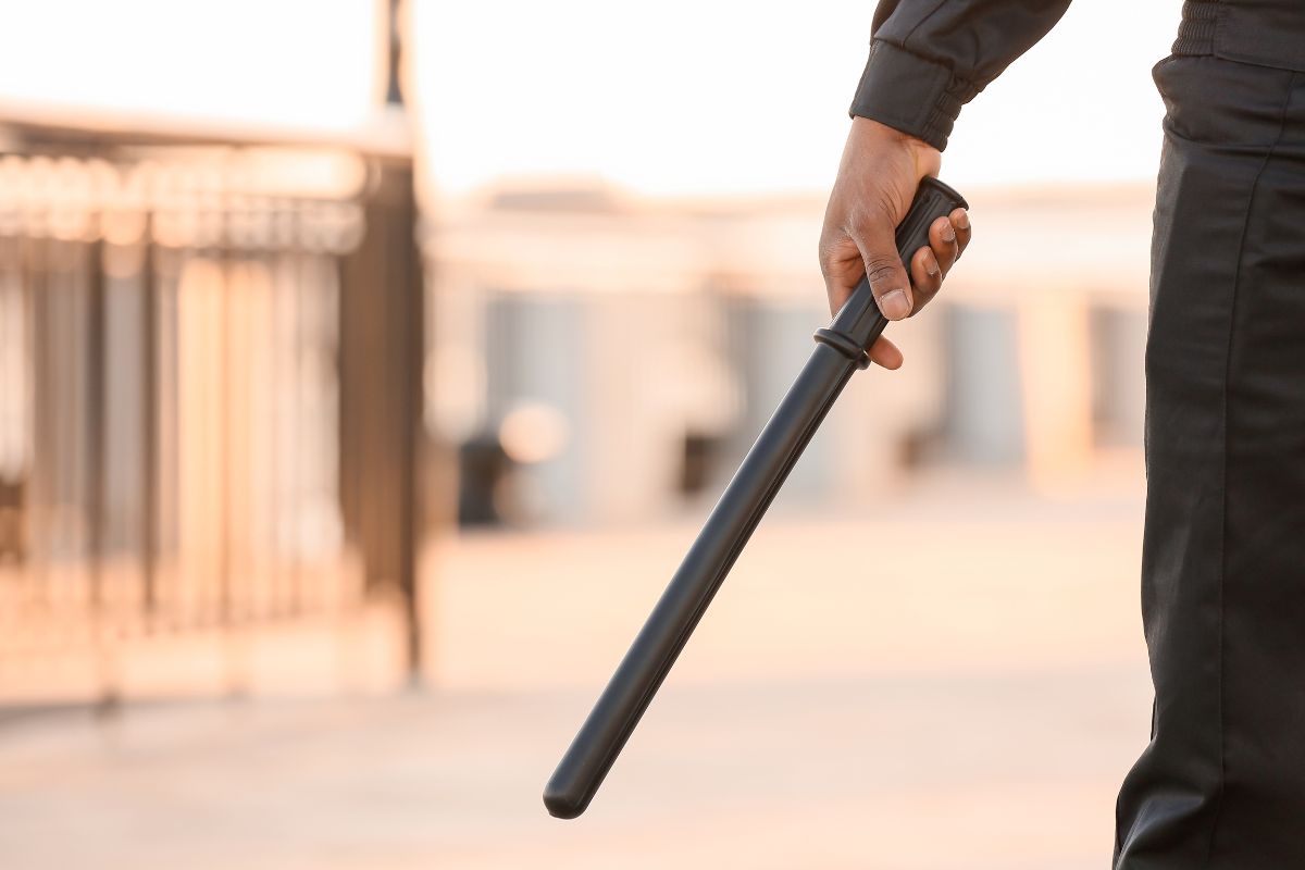 Man holding a baton in his hand.