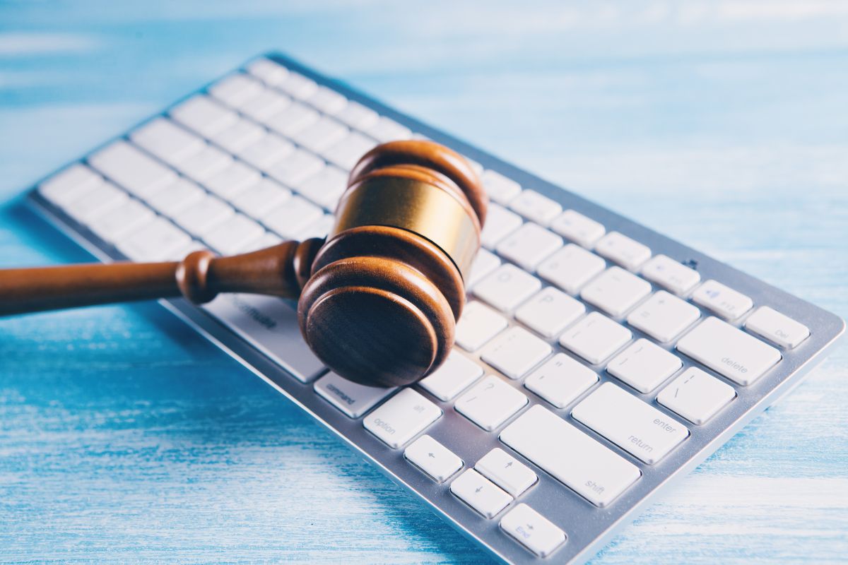 A judge’s gavel placed on a computer keyboard.