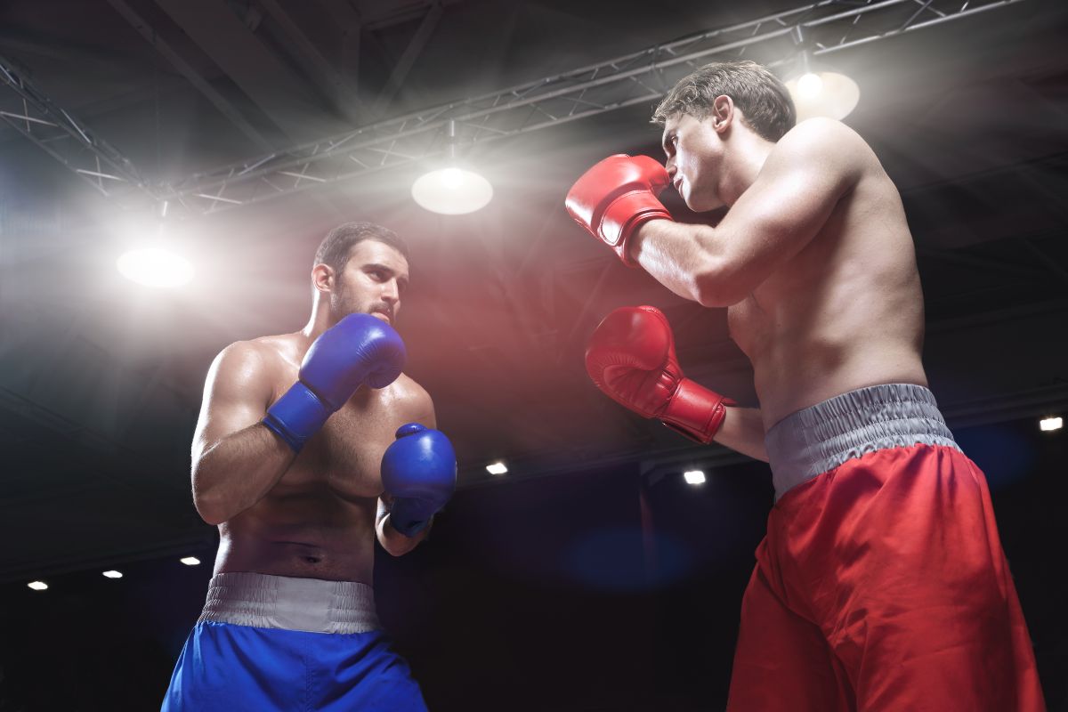 Two male boxers facing off in a boxing ring.