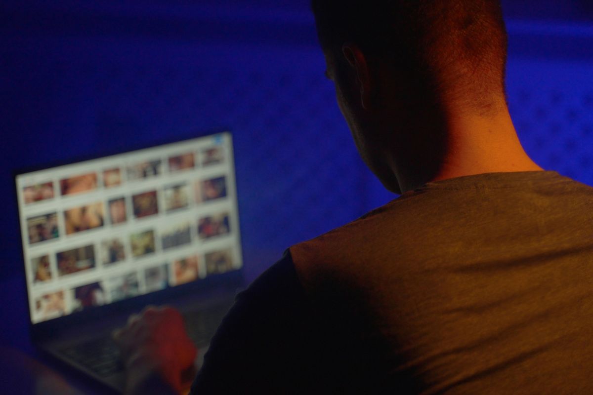 Man viewing explicit content on a laptop.
