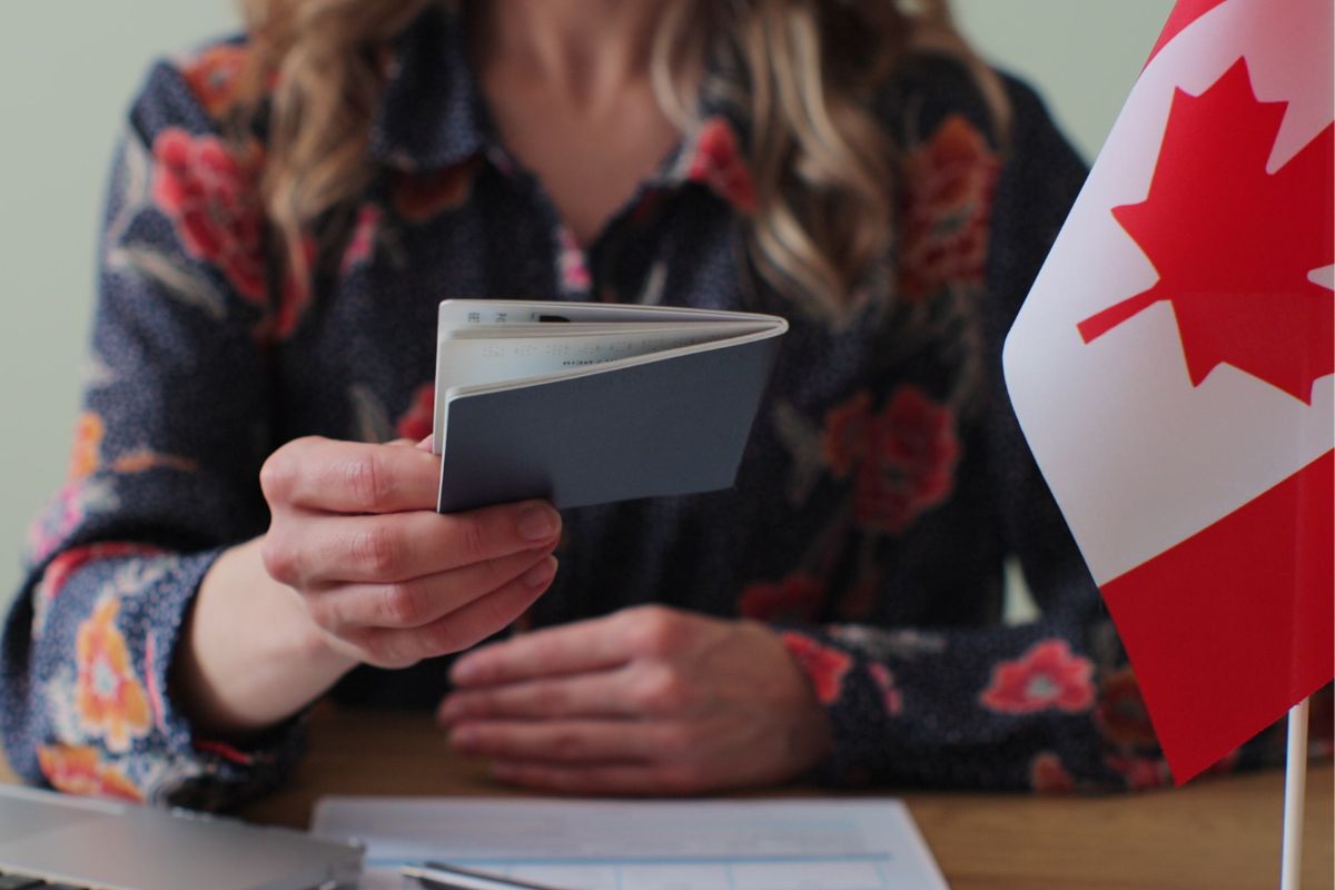 Woman holding a Canadian passport.