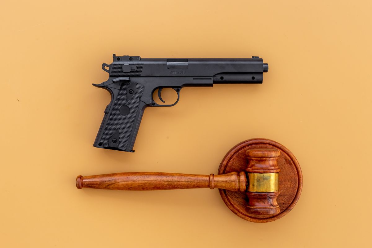 Handgun, weapon, and a judge's gavel.