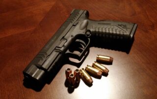 Black handgun with bullets.