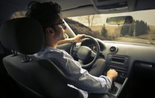 Man driving a car.