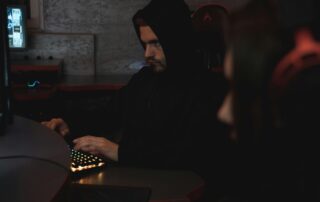 A man using a computer posing as someone else online.