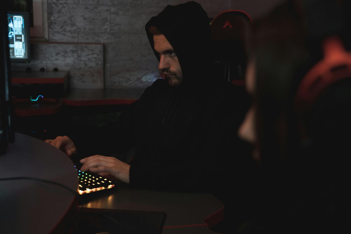 A man using a computer posing as someone else online.