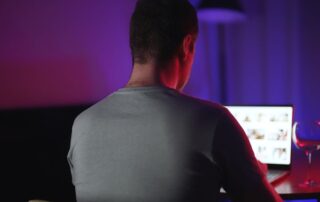 A man is viewing explicit content on a laptop.