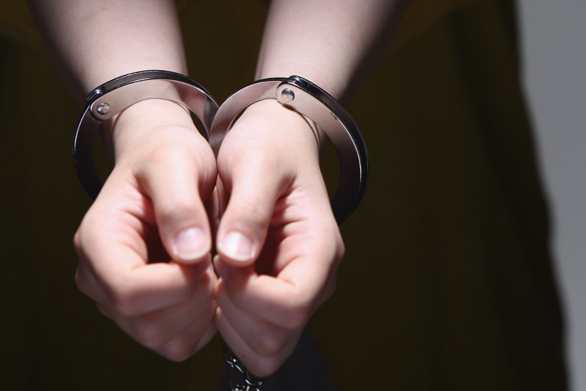 Close-up of a person's hands in handcuffs.