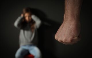 Clenched fist with scared person.