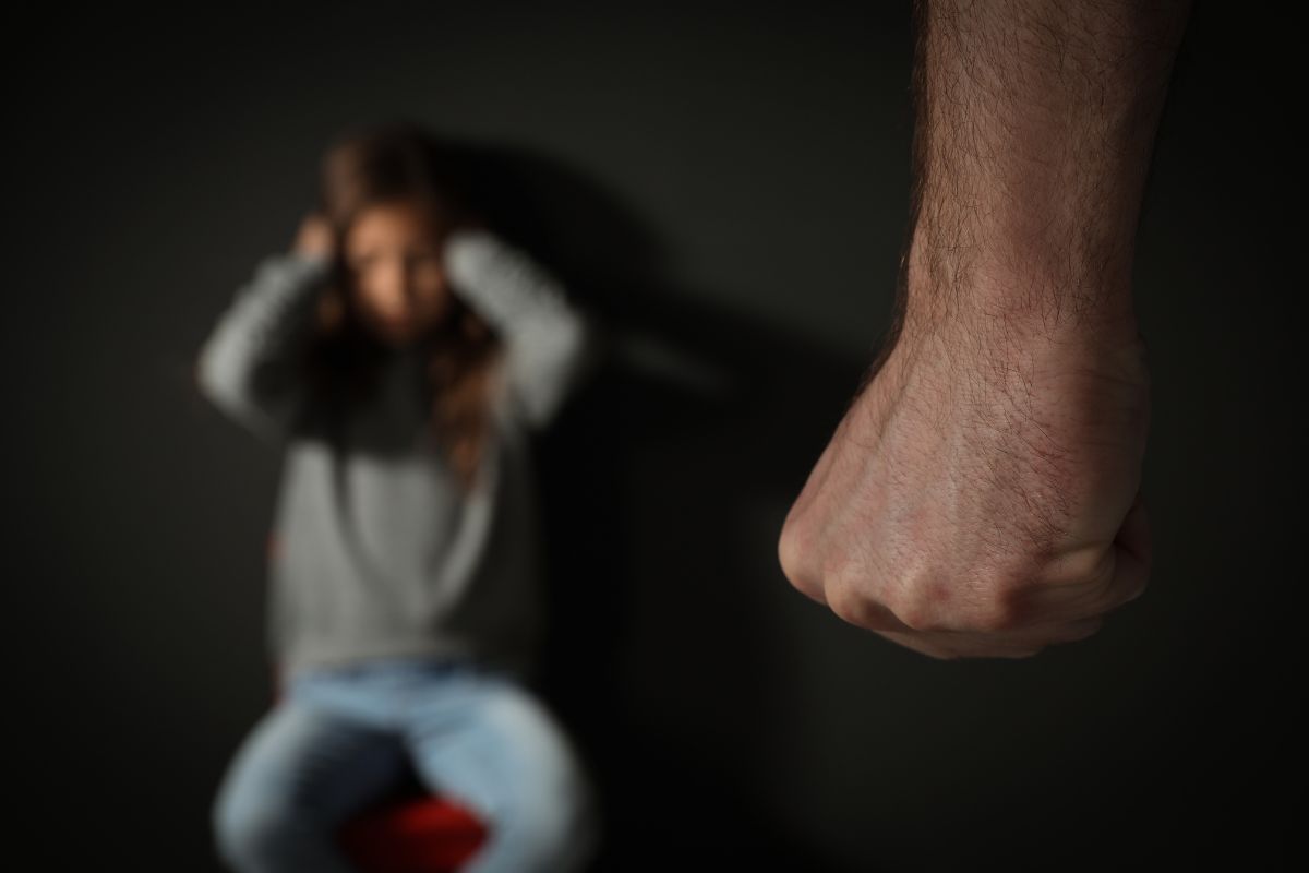 Clenched fist with scared person.