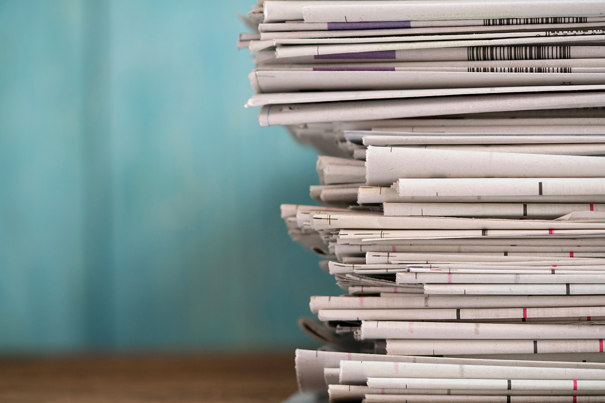 Folded newspapers sitting on a table