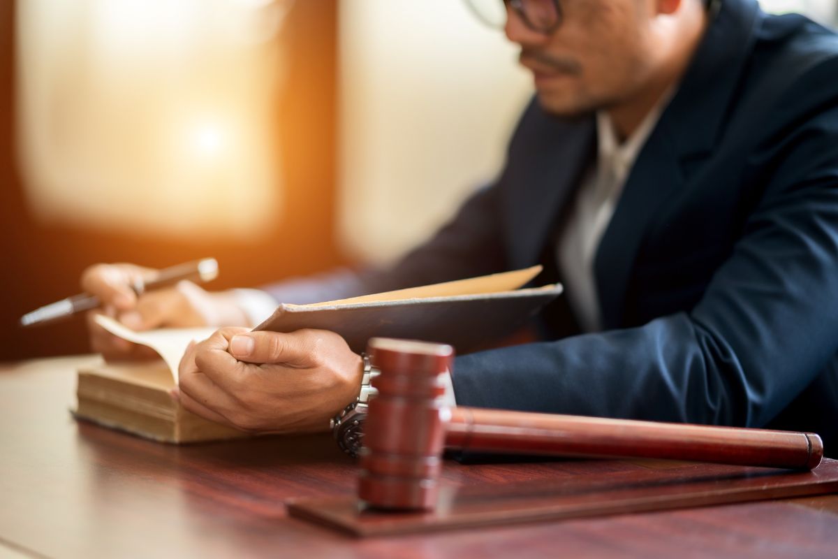 Lawyer reviewing documents at a desk.