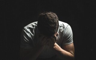 Distressed man sitting.