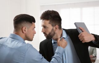 Two men in a physical confrontation indoors.